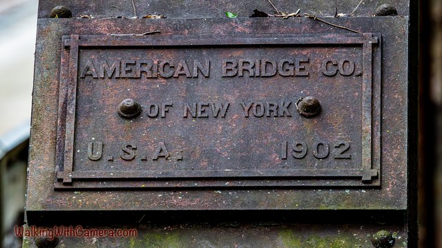 A weathered metal plaque reads American Bridge Co., Of New York, U.S.A., and 1902.